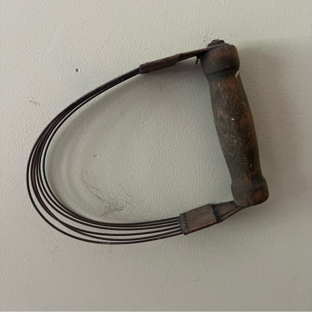 Antique dough mixer with wooden handle.